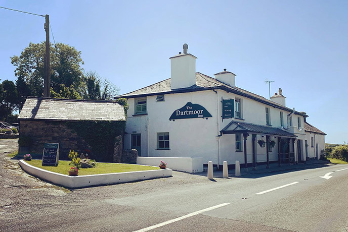 The traditional white exterior of The Dartmoor Inn