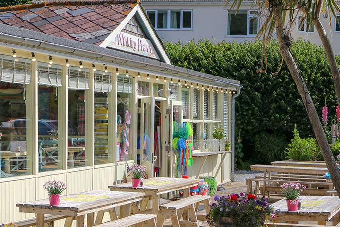 The classically beachside front of The Winking Prawn with plenty of outside seating for sunny days