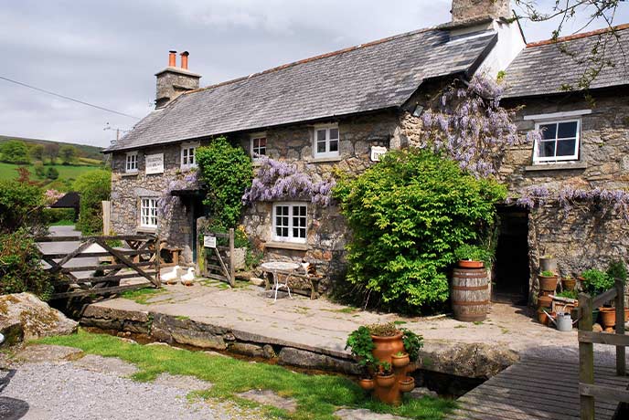 The stone exterior of The Rugglestone Inn in Devon