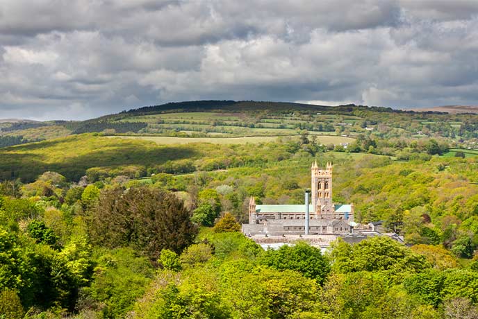 Buckfast Abbey towering above the surrounding trees in Dartmoor National Park