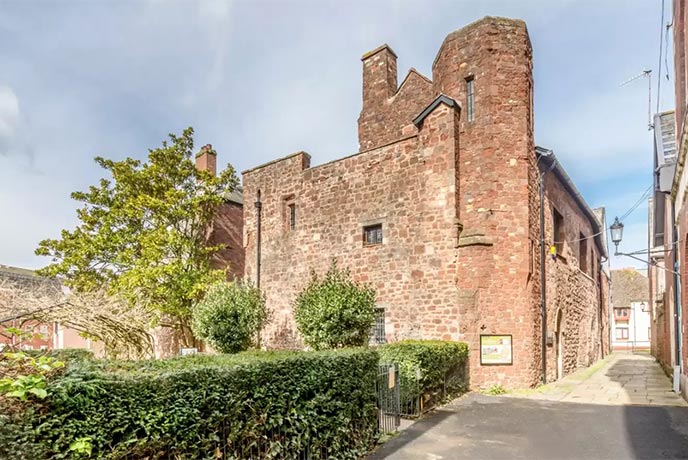 The historic, red bricked St Nicholas Priory in Exeter