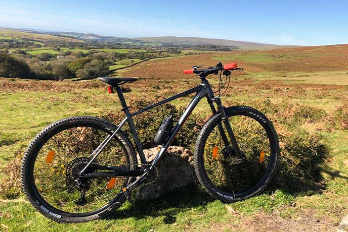 A bike stood up in Dartmoor with the moors behind