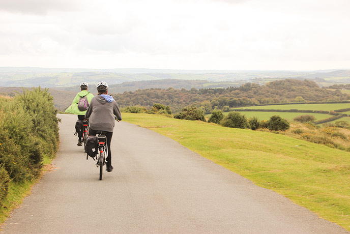 Two people cycling across Dartmoor in Devon