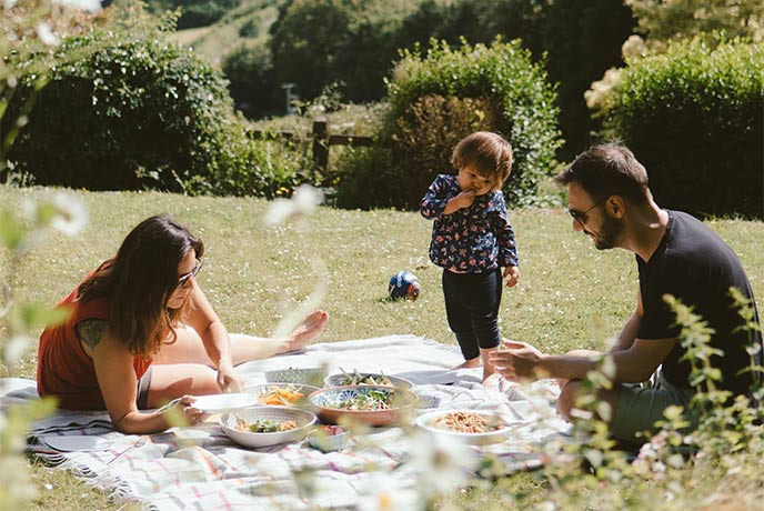 A family having a picnic in the garden at Barnell Cottage in Devon