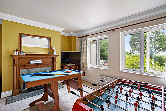 The colourful games room at Hope House full of table football and billiards