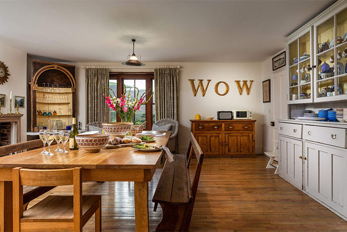 The dining room at Meadowgate cottage with food and drink on the kitchen island