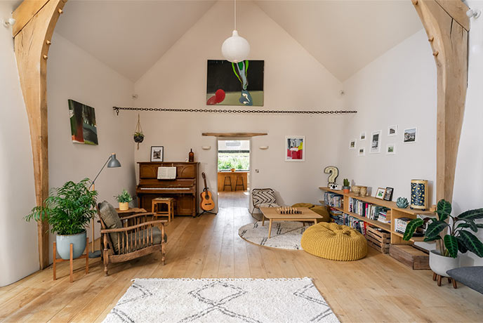 Looking across the open plan living area where a games area and piano sit