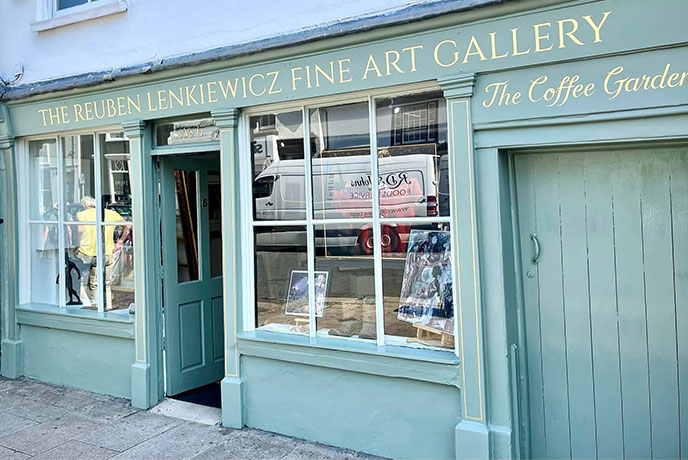 The soft blue, wooded exterior of The Reuben Lenkiewicz Fine Art & Antiques Gallery
