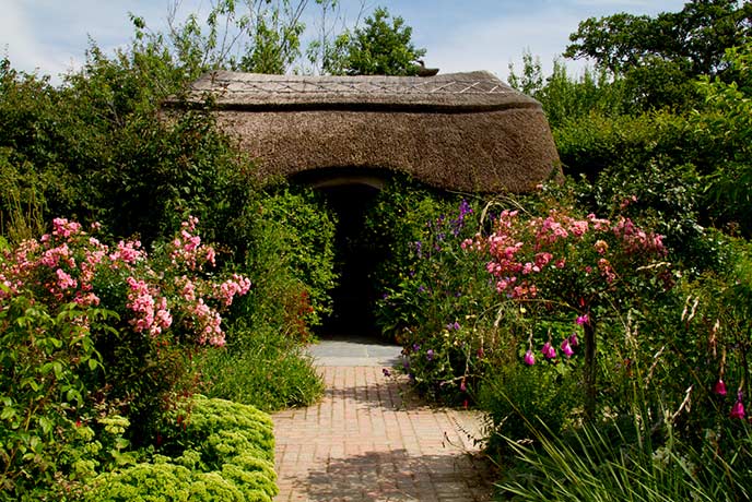 A charming thatched building hidden amongst the flowers at RHS Garden Rosemoor