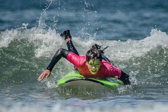 A teenage boy surfing at the North Devon Surf School