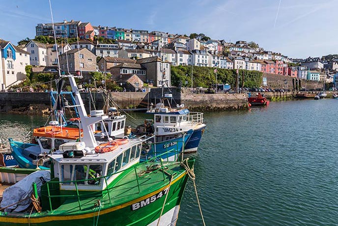 Colourful boats bob in the harbour at Brixham, where there are some of the best places to eat in South Devon