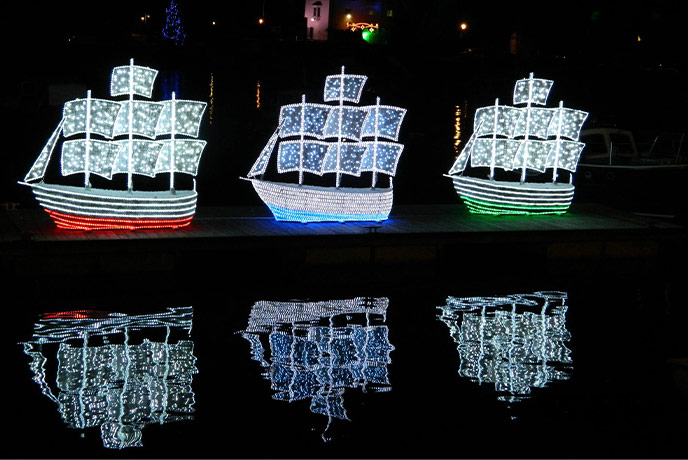 Three ship Christmas lights in Brixham harbour as a part of the Lights, Lanterns & 'Luminations event