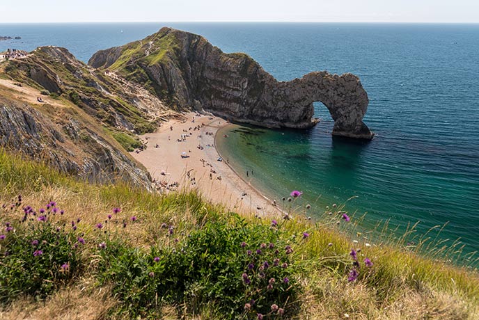 Looking down the headland at the beautiful beach and impressive arch at Durdle Door in Dorset