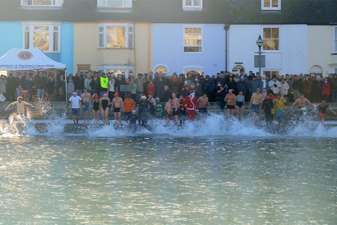 People jumping in the sea as part of the Weymouth Christmas Day swim in Dorset