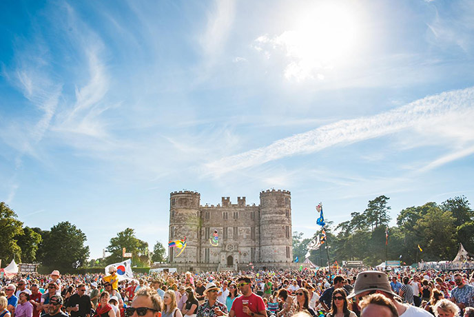 A crowd of people in front of Lulworth Castle at Camp Bestival Dorset