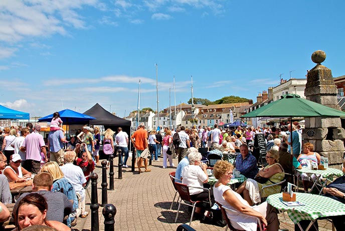 People walking along the seafront at Seafest in Dorset