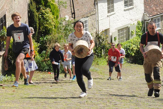 People running up the hill in the cheese race at Shaftesbury Food and Drink Festival