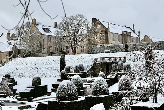 The beautiful grounds at Mapperton House covered in snow at Christmas