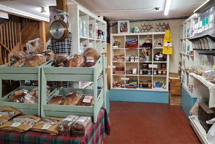 Shelves stacked with local foods at Goldhill Organic Farm Shop in Dorset