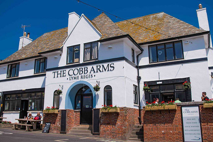 The white and traditional exterior of The Cobb Arms