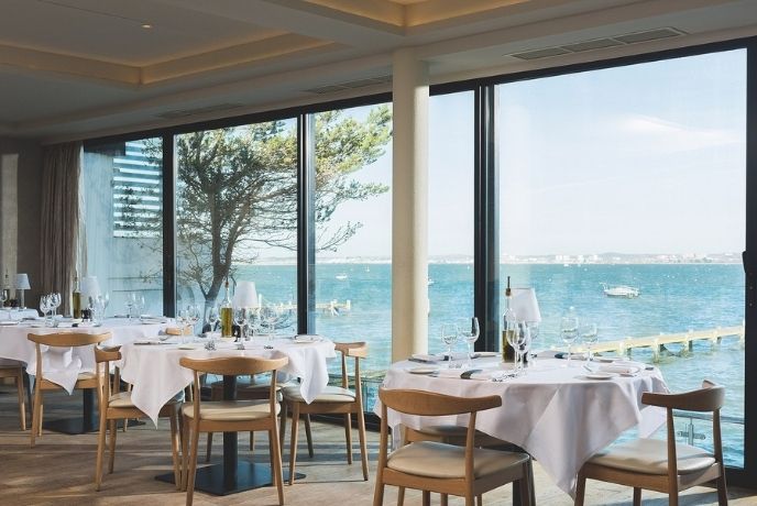 Looking out over the tables and through the windows of Rick Stein at the harbour, Sandbanks in Poole