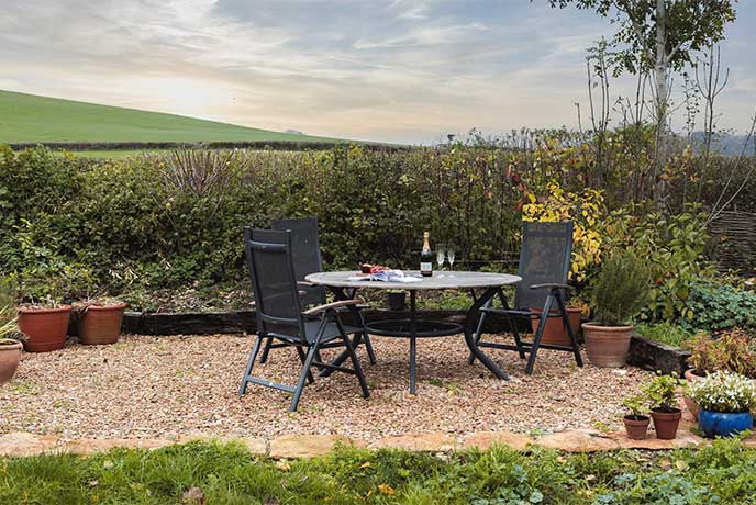 The pretty al fresco dining area overlooking the fields at Poorton House in Dorset