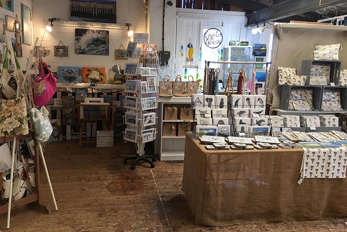 A selection of paintings, cards, and gifts on display at Purbeck Artisan Yard in Dorset