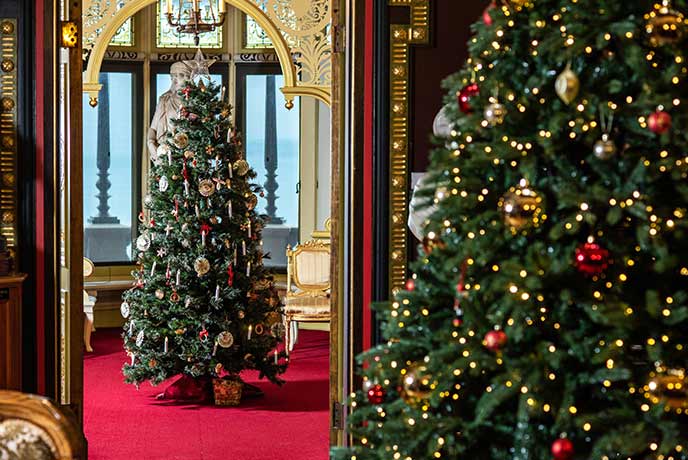 Two beautifully decorated Christmas trees at Russell-Cotes Art Gallery and Museum in Dorset