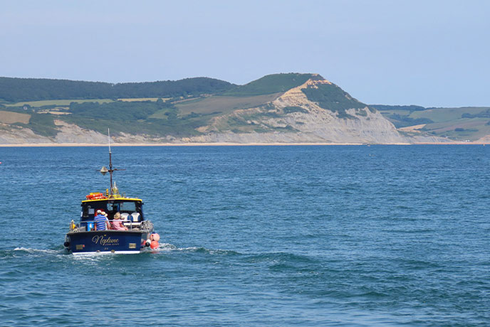 One of the Lyme Bay Boat Trips sailing along the Dorset Coast