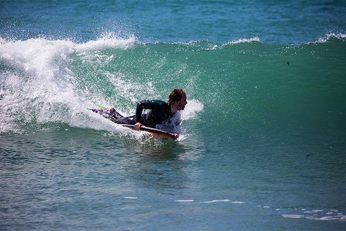 Someone bodyboarding a wave in Cornwall