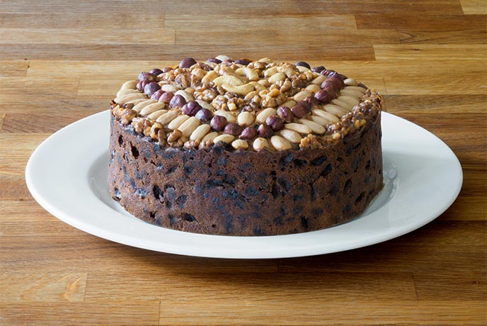A Dundee cake decorated with almonds and other nuts