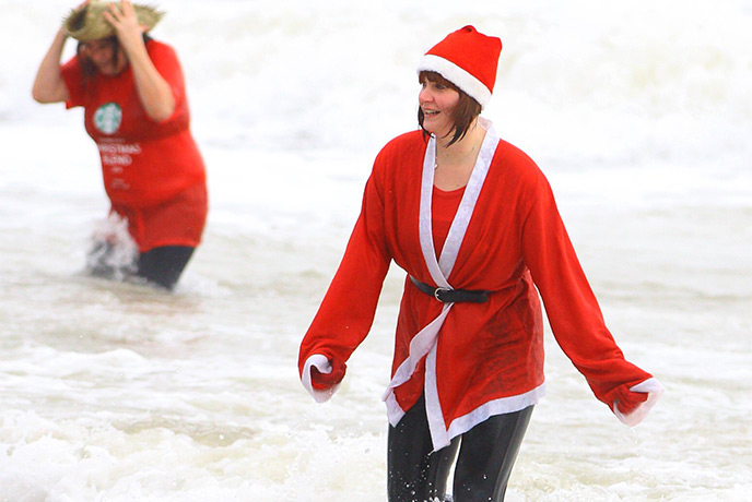 Someone swimming on Christmas Day dressed as Father Christmas