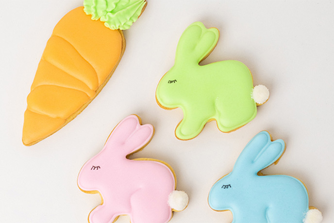Easter biscuits decorated in pastel colours as rabbits and Easter eggs