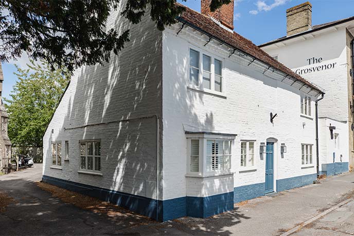 The pretty white exterior of Tap Cottage in Hampshire