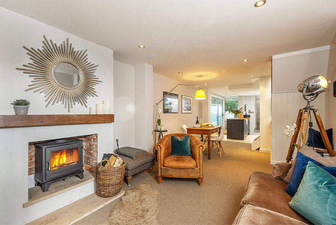 The cosy living room at Yachtsmans Cottage, with a roaring fire, the perfect romantic cottage for couples