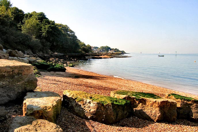 The golden tones of the shingle and rock beach hidden by Gurnard's beach on the Isle of Wight