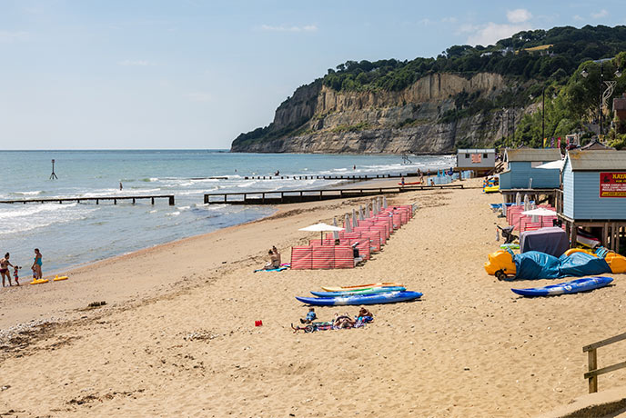 Kayaks sit on the golden sand at Shanklin beach waiting for eager visitors