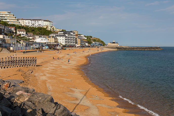 Looking down the golden sands of Ventnor beach, backed by the popular town