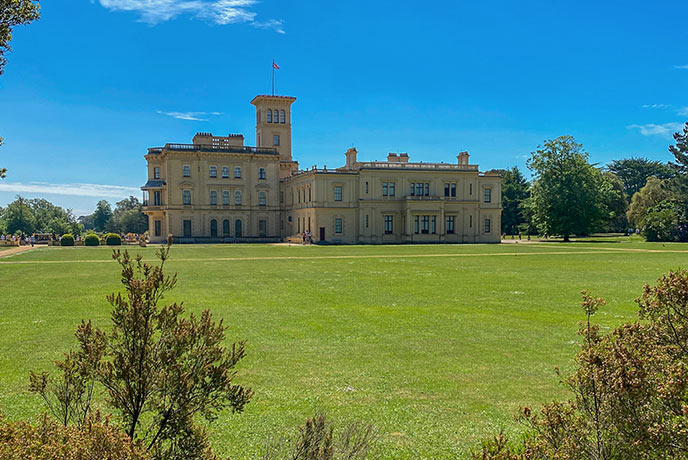 The impressive façade of Osborne House, surrounded by perfectly manicured lawns