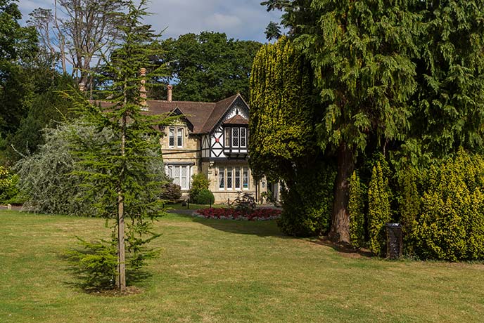 The stunning Tudor house poking through the trees at Rylstone Gardens
