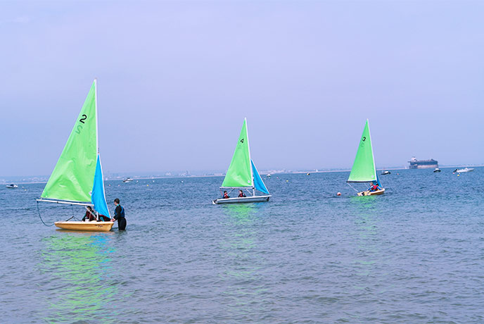 Three small sailing boats in the water in Seaview on the Isle of Wight