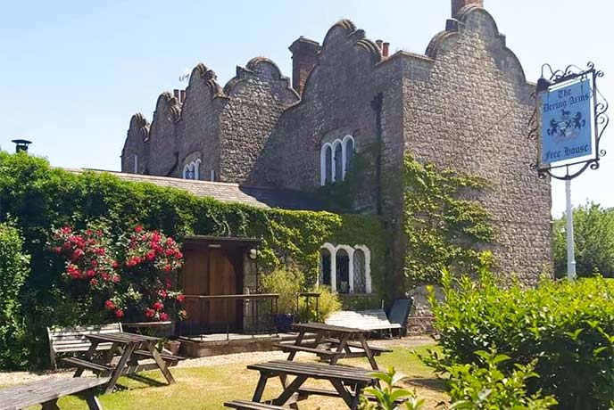 The sun-soaked beer garden and quirky stone exterior of the Dering Arms in Kent