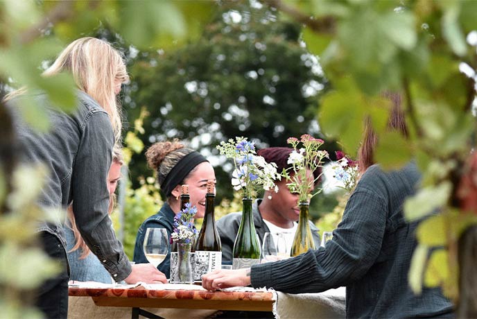 People enjoying a wine tasting at Westwell vineyard in Kent