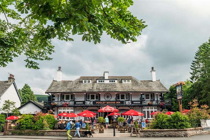 The traditional exterior and beer garden at Pooley Bridge Inn in the Lake District