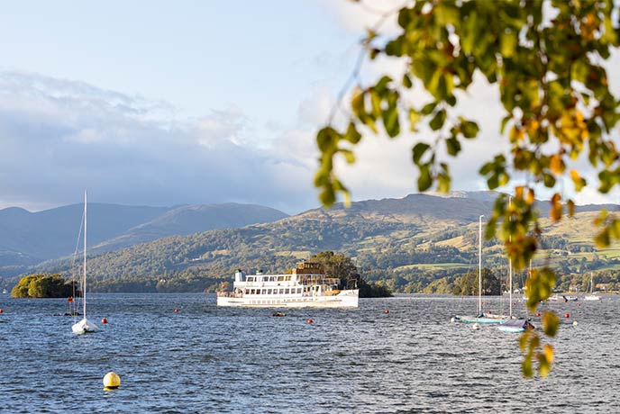 A large boat sailing across Lake Windermere in the Lake District