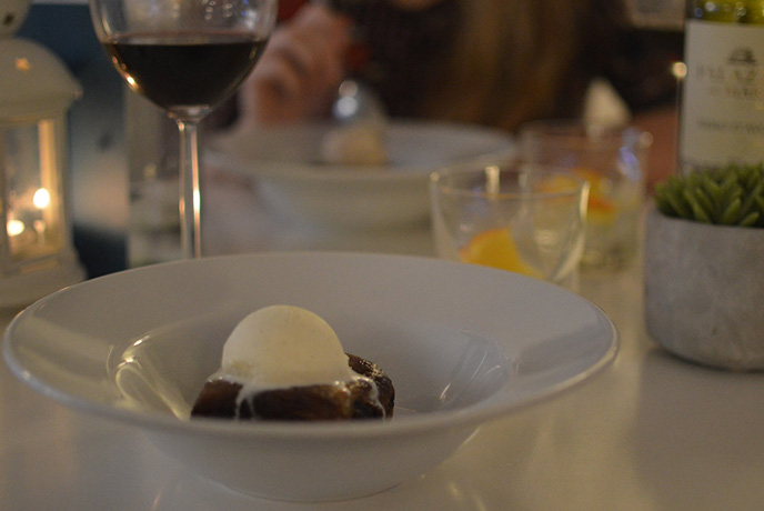 Cinnamon and chocolate bun dessert with a refreshing scoop of vanilla ice cream at Muddy Beach cafe in Penryn.
