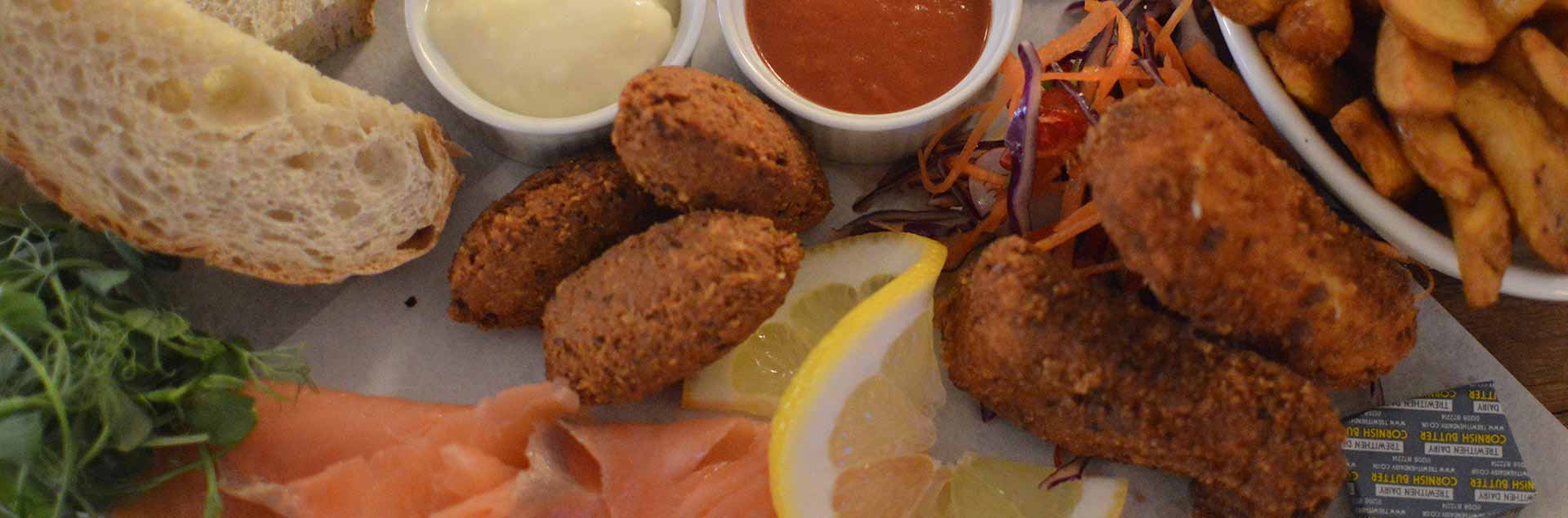 The seafood beach board: salmon, crab fritters, chips, bread and haddock goujons with dips and side salad. A tasty option for one or to share between you.