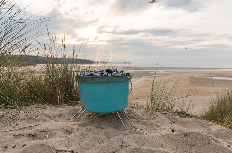 Find a sheltered spot on the beach so you can light your barbecue with ease.