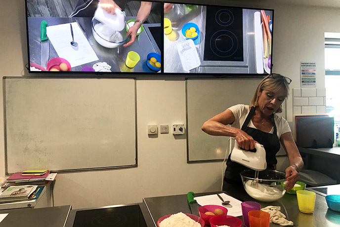 Maria showing us how it's done on the big screen at Truro School Cookery in Cornwall.