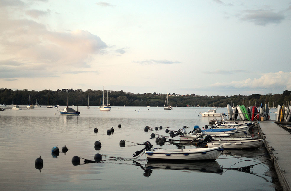 Boats moored to the pier on the River Dart. From Dittisham, you can get a river taxi to Agatha Christie's Greenway.